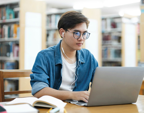 Student on laptop in library